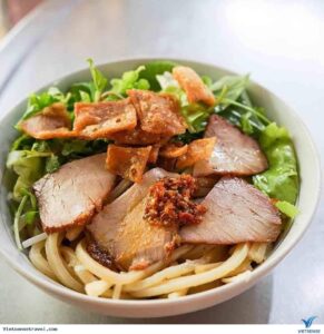 Cao lau noodle dish with pork and crispy crackers in Ho Chi Minh City