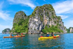 Kayak in Bai Tu Long Bay, a peaceful must-visit attraction in Ha Long Bay for hidden gems in Vietnam.